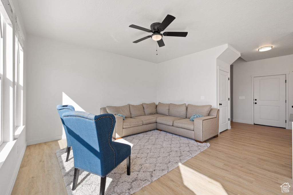 Living room with light wood-type flooring and ceiling fan