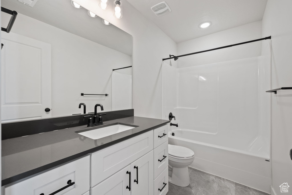 Full bathroom featuring shower / washtub combination, vanity, and toilet