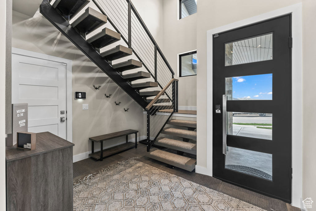 Foyer entrance featuring a towering ceiling