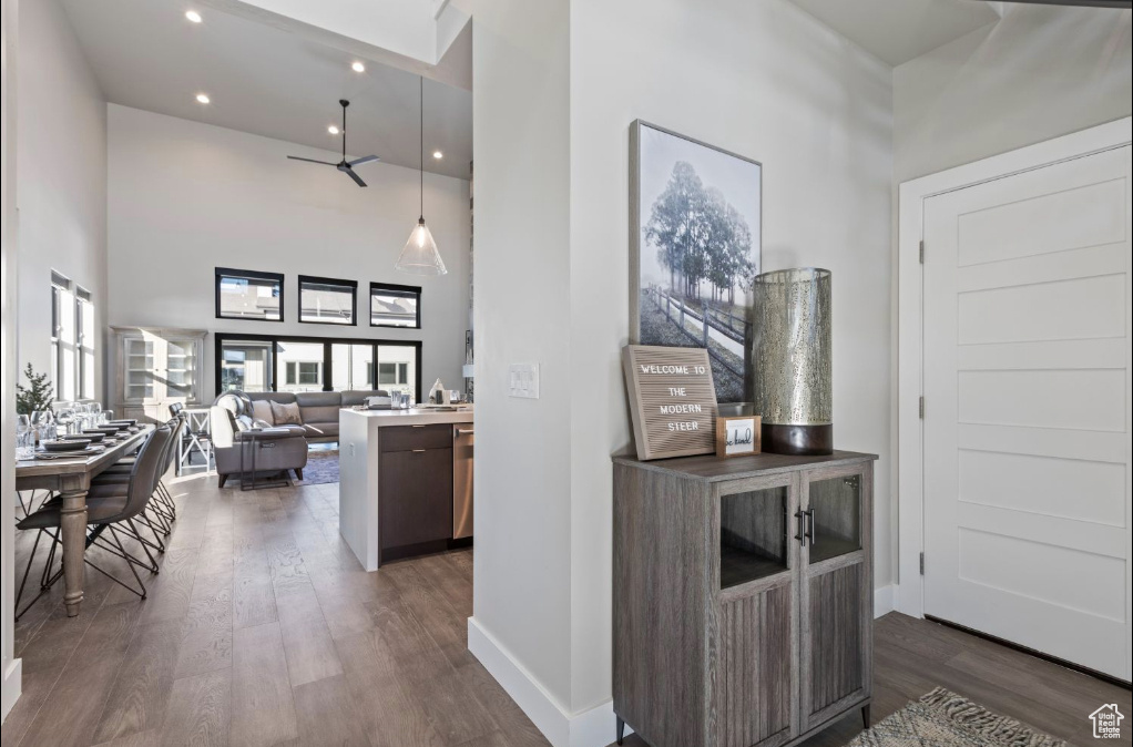 Interior space featuring dark hardwood / wood-style flooring and a towering ceiling