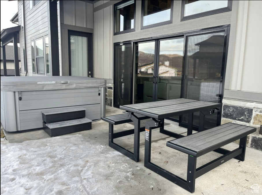 View of patio / terrace with a hot tub