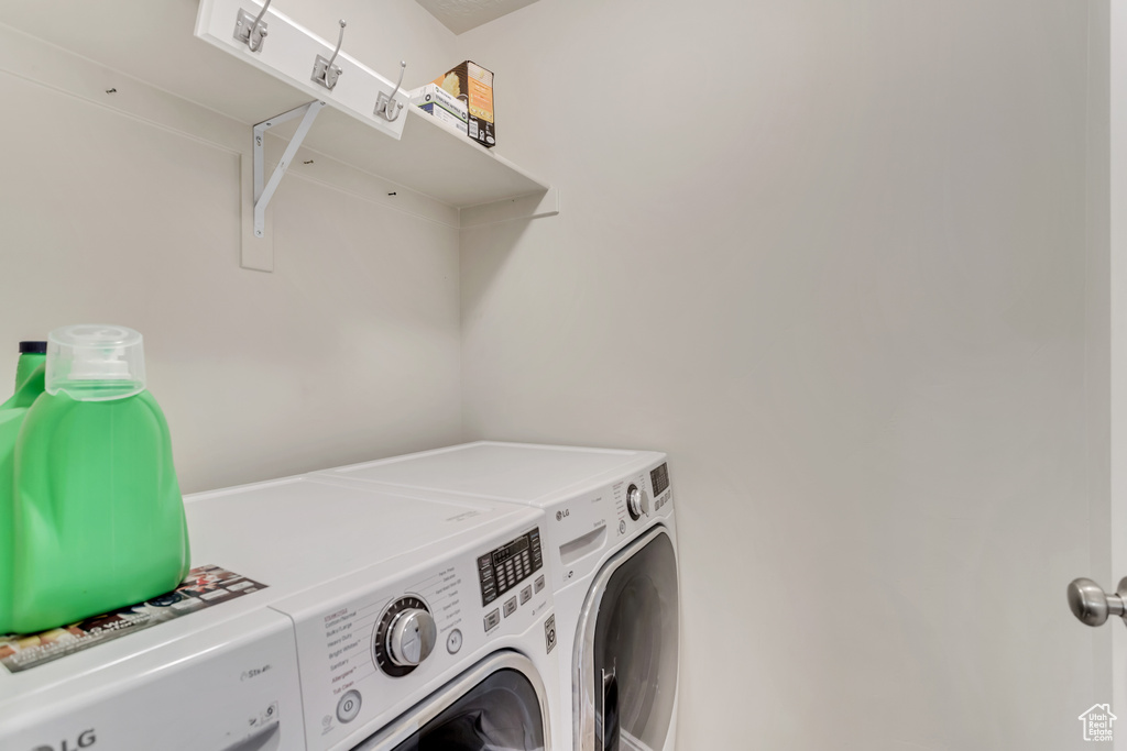 Laundry room with washing machine and clothes dryer