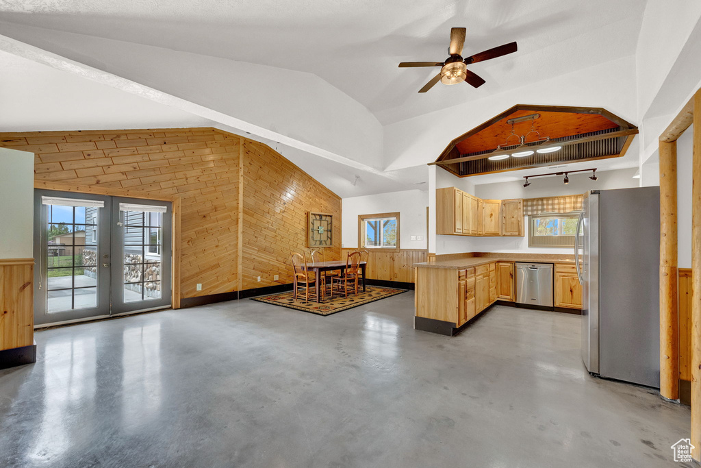 Kitchen with light brown cabinetry, appliances with stainless steel finishes, concrete flooring, and ceiling fan