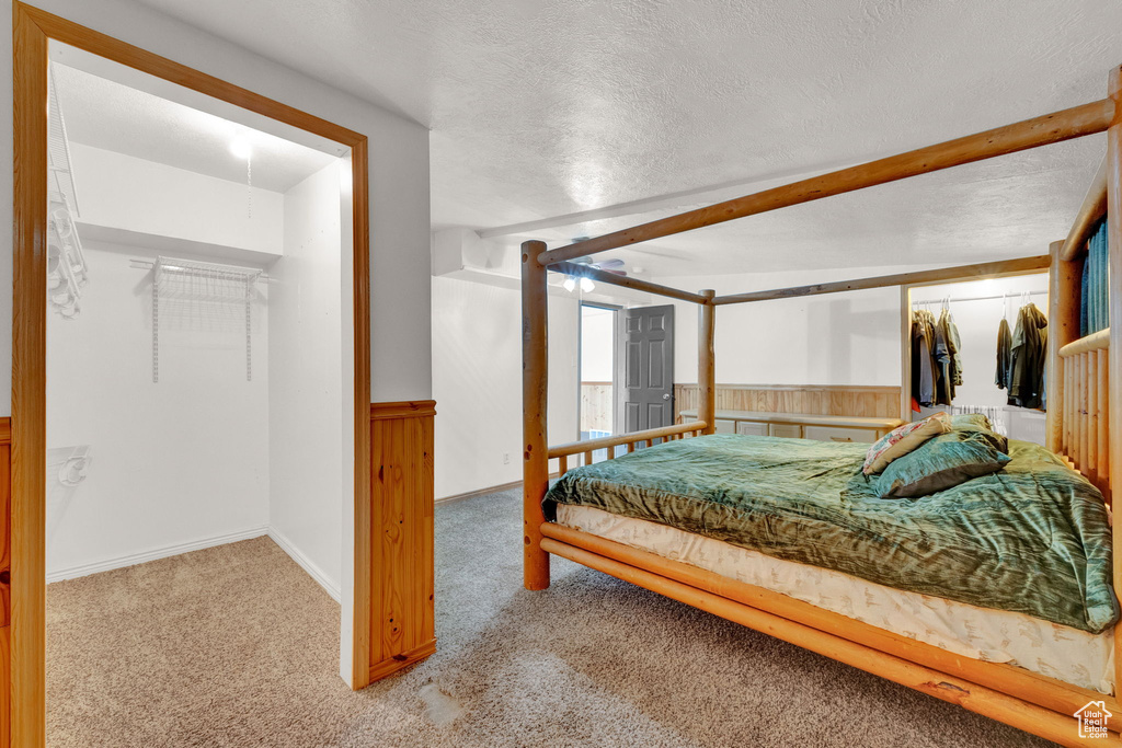 Carpeted bedroom featuring a closet and a textured ceiling
