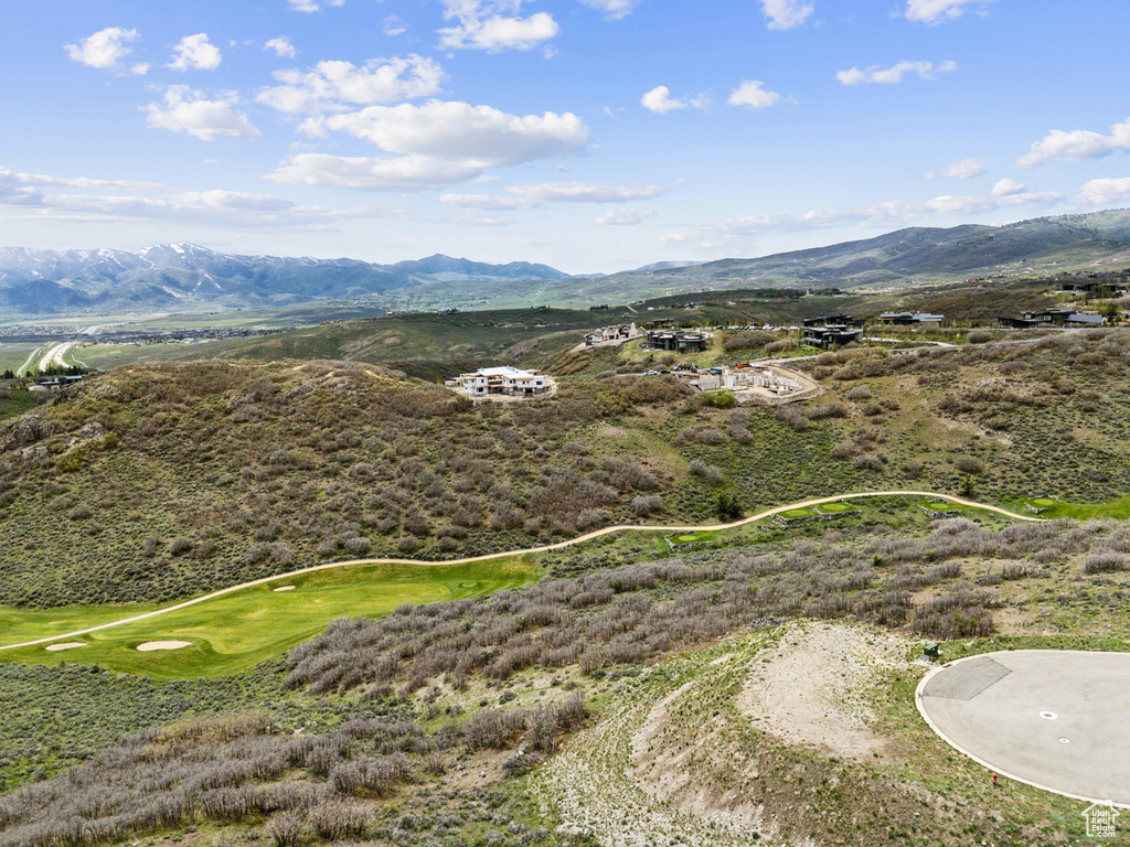 Drone / aerial view of a mountainous background and a local golf course