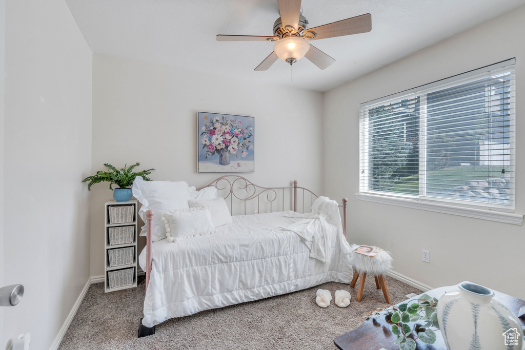 Bedroom featuring ceiling fan and carpet floors