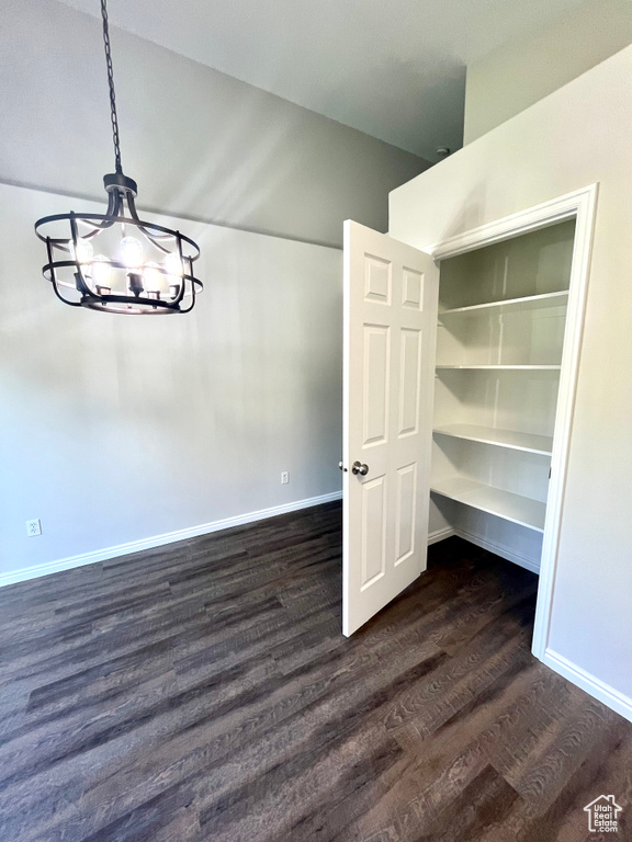 Interior space featuring a chandelier and dark hardwood / wood-style floors