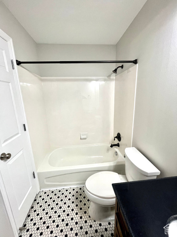 Full bathroom featuring tile patterned floors,  shower combination, vanity, and toilet