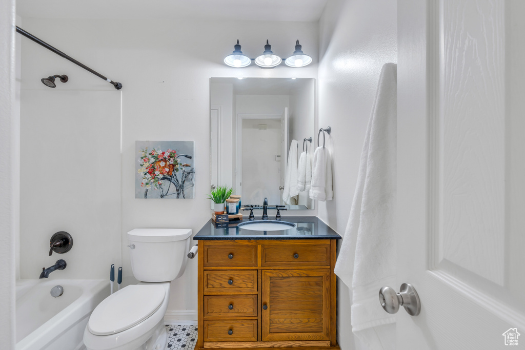 Full bathroom featuring shower / washtub combination, toilet, tile flooring, and vanity