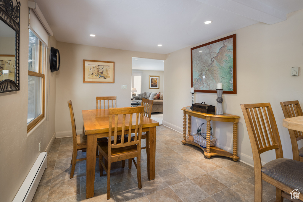 Dining area featuring tile flooring and a baseboard radiator