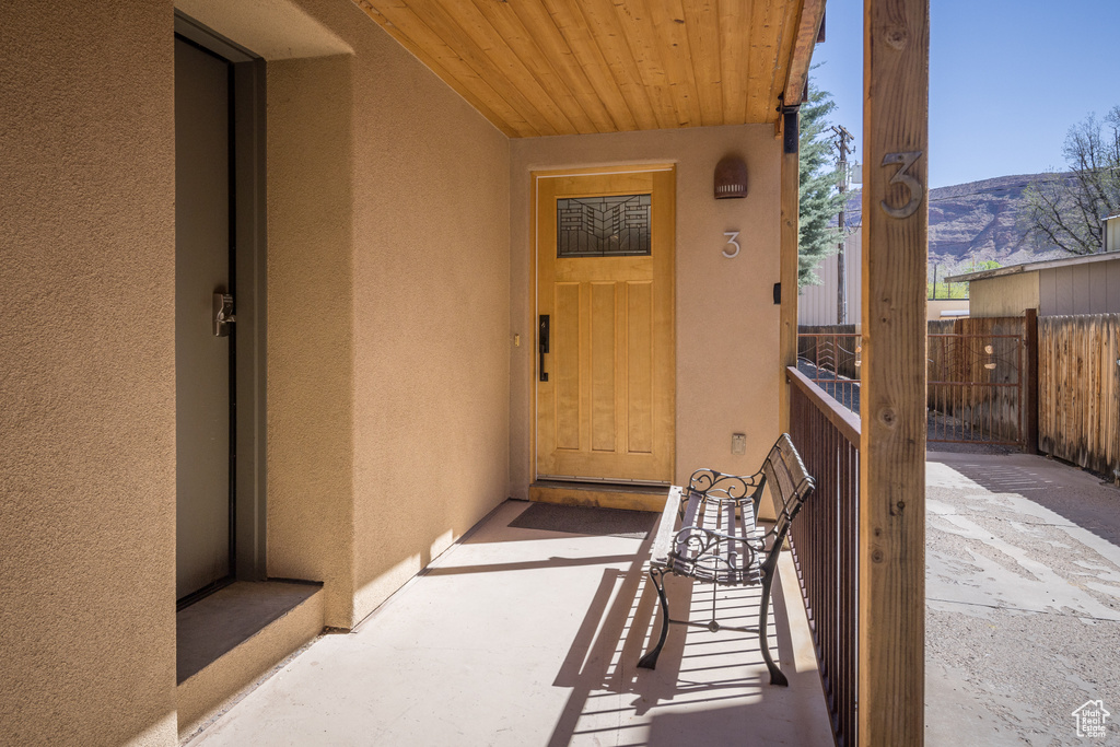 Doorway to property featuring a mountain view and a patio