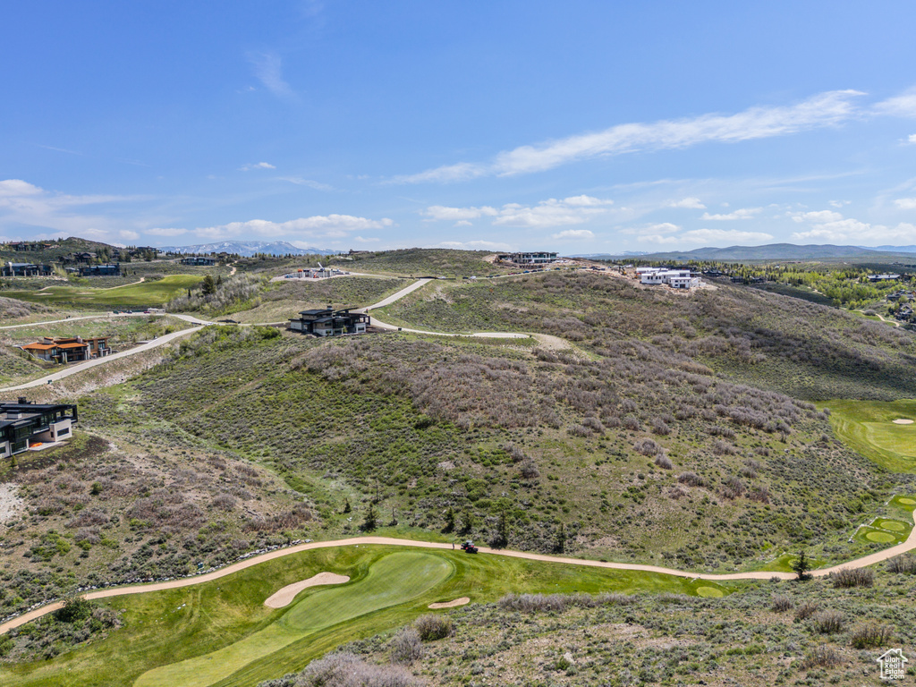 Drone / aerial view of a local golf course and a mountain backdrop