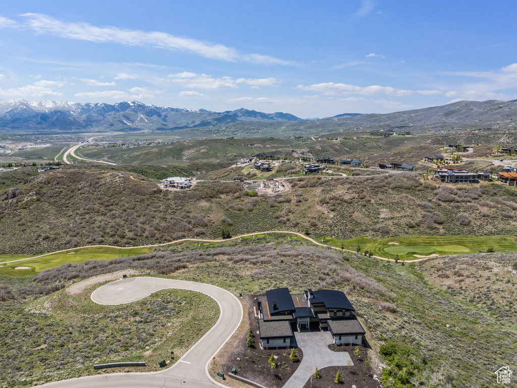 Aerial view of a mountain backdrop and a golf course