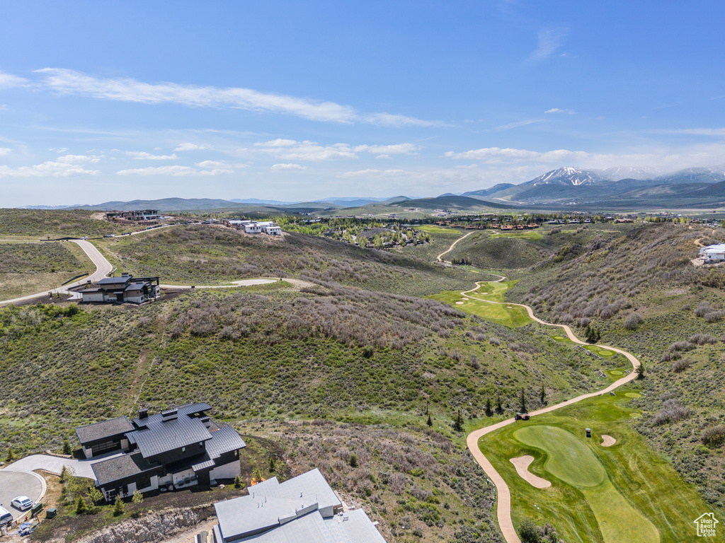 Aerial view of a mountainous background and a golf course
