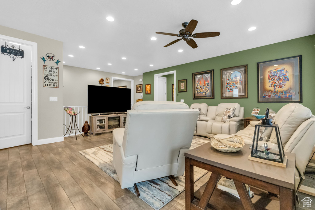 Living room with wood-type flooring and ceiling fan