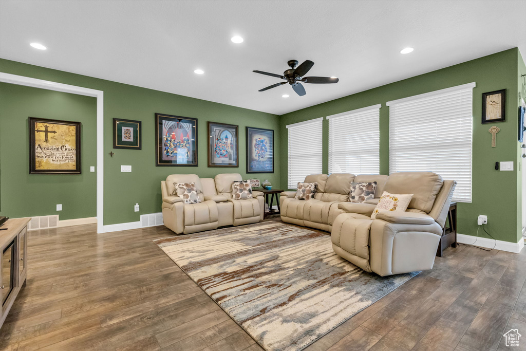Living room with hardwood / wood-style floors and ceiling fan