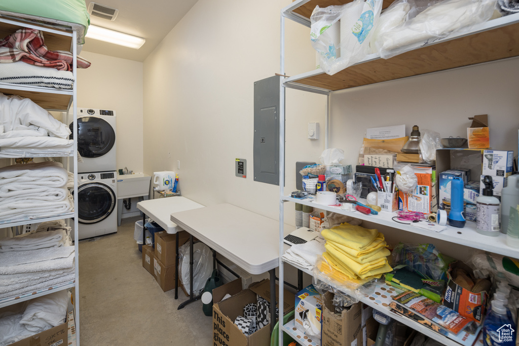 Storage room with stacked washer / dryer and sink