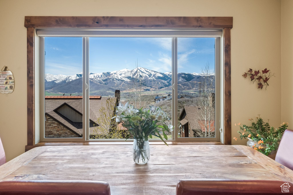 Dining space featuring a healthy amount of sunlight and a mountain view