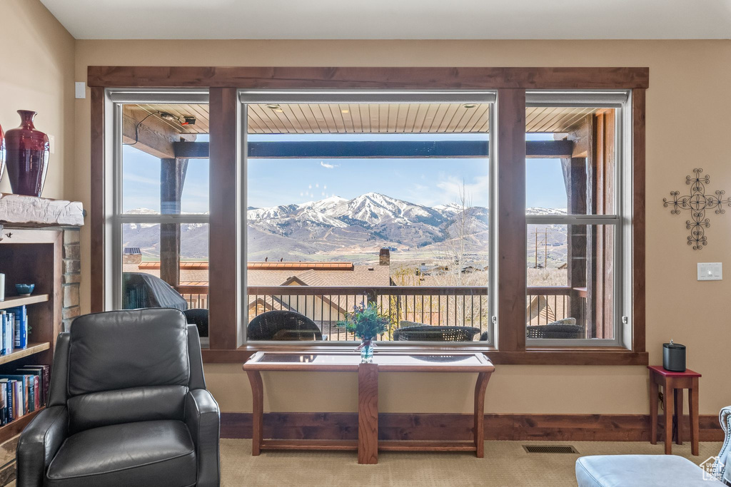 Living area featuring carpet floors and a mountain view