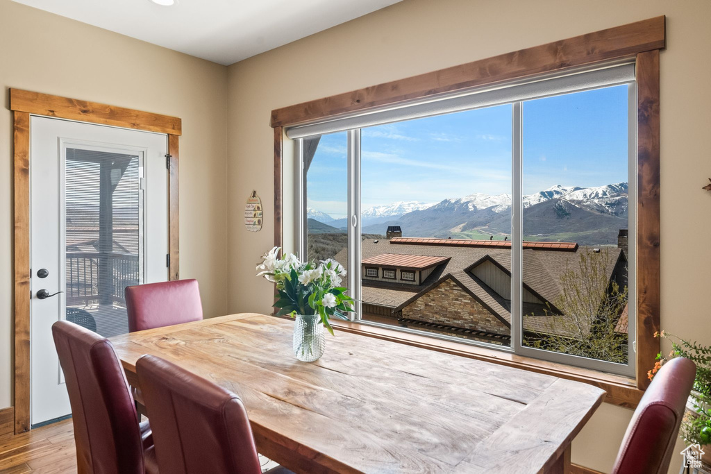Dining space with a mountain view and hardwood / wood-style floors