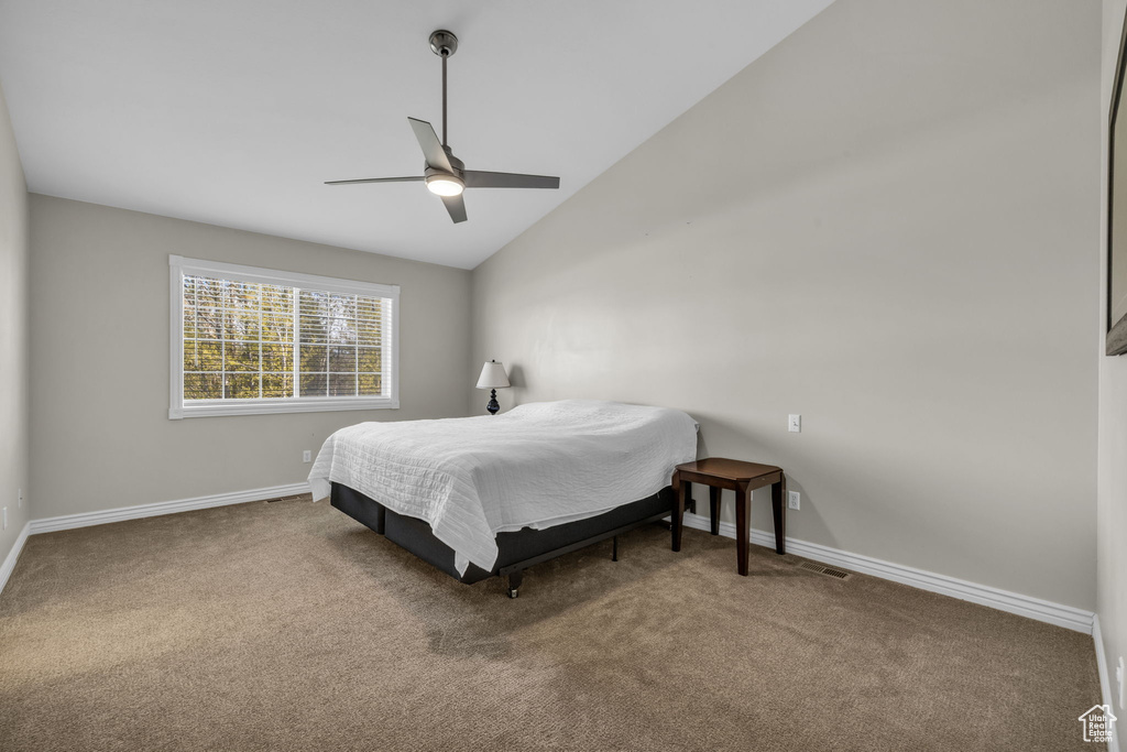 Bedroom featuring lofted ceiling, carpet floors, and ceiling fan