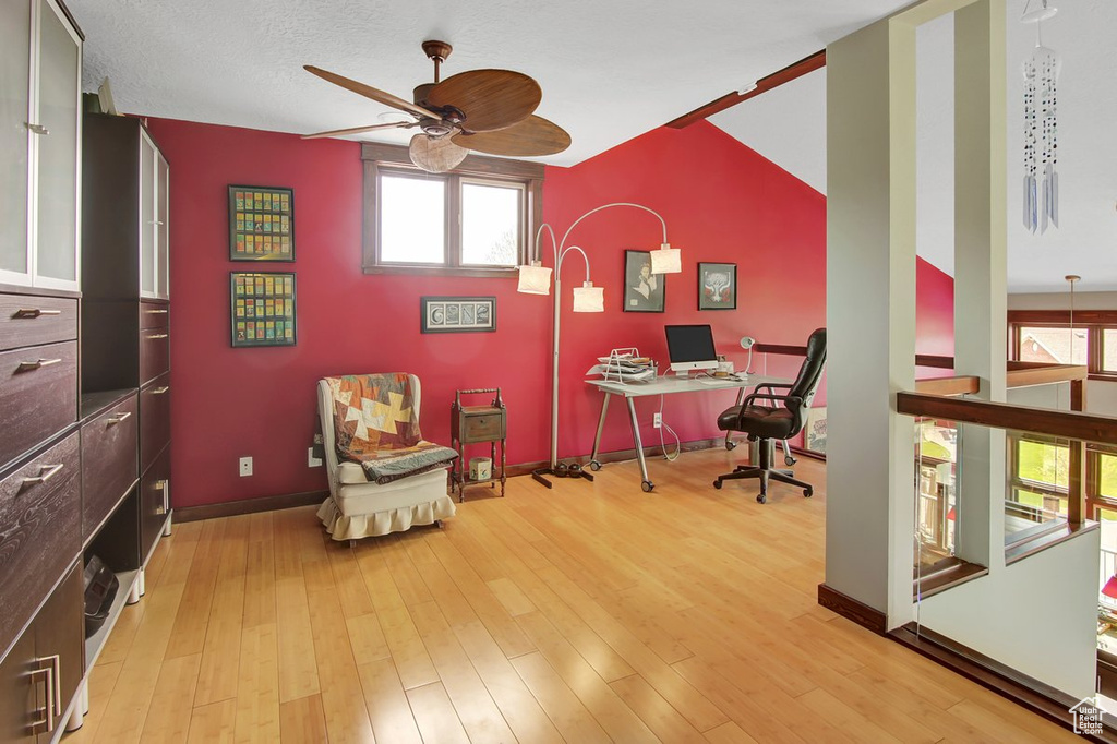 Office space with light hardwood / wood-style floors and ceiling fan