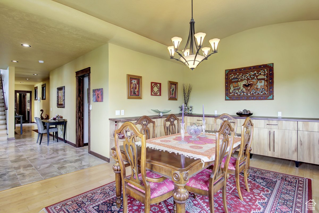 Dining space with light tile floors and an inviting chandelier