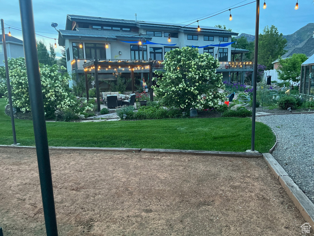 View of home\'s community with a pergola and a lawn