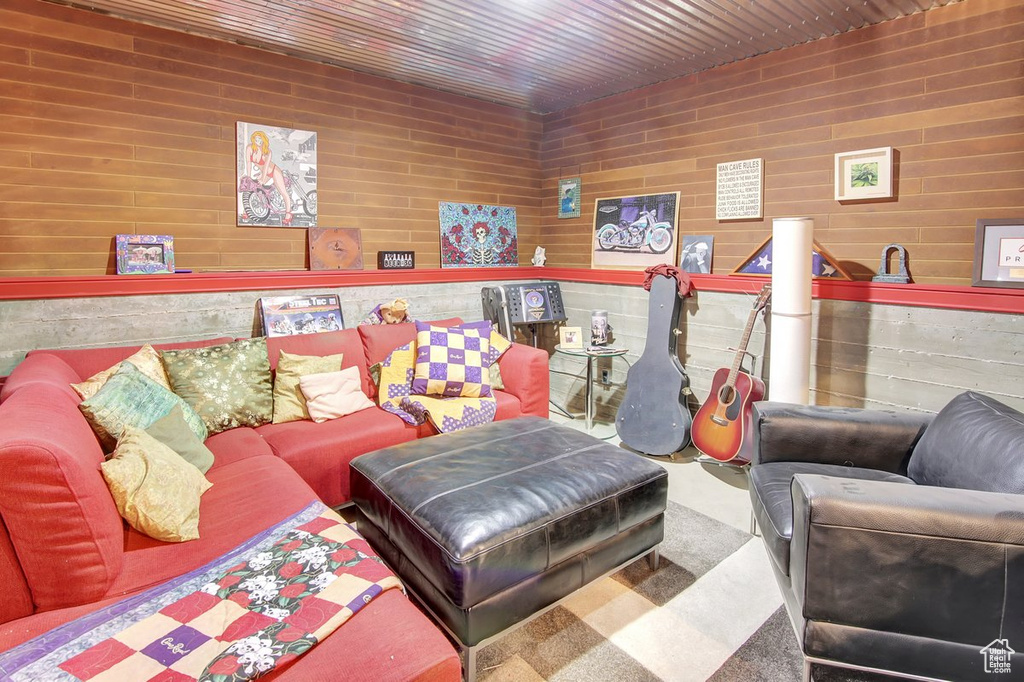 Living room featuring wooden ceiling and wood walls