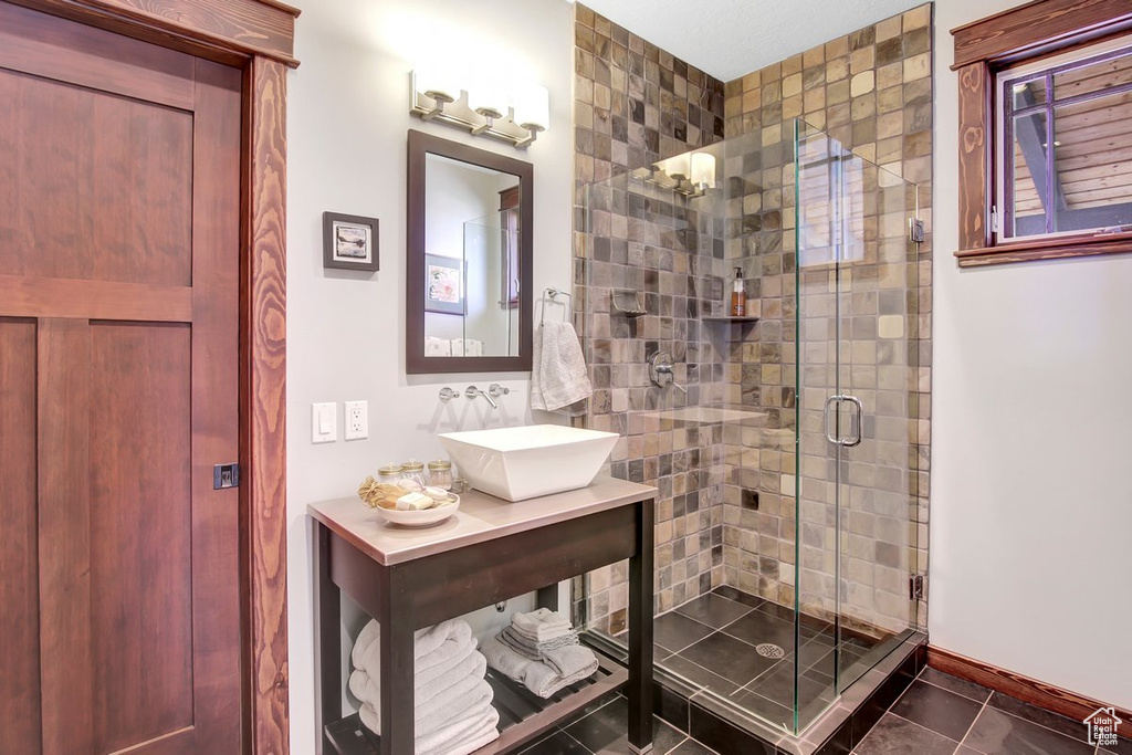 Bathroom featuring walk in shower, tile flooring, and large vanity