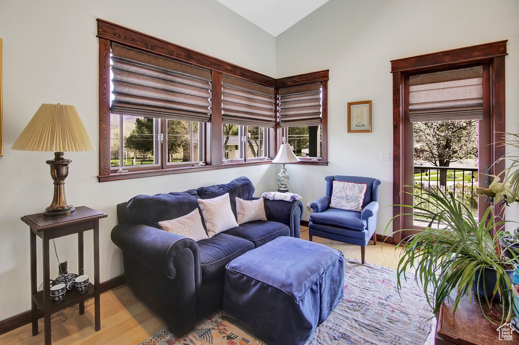 Living room with wood-type flooring and vaulted ceiling