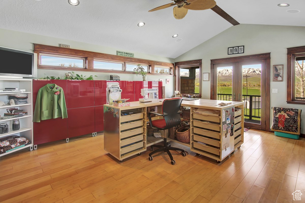 Home office featuring french doors, light hardwood / wood-style flooring, ceiling fan, and vaulted ceiling