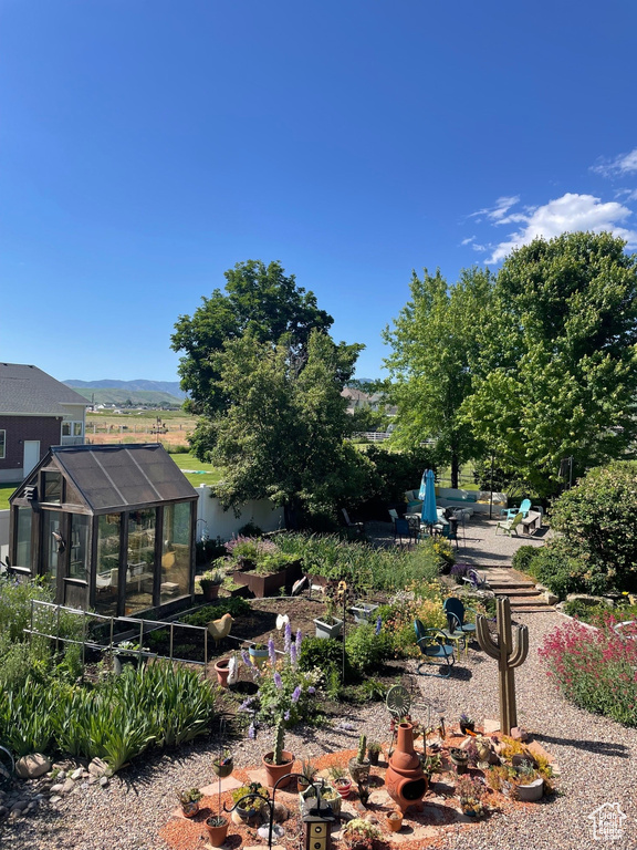 View of yard with a mountain view and a sunroom