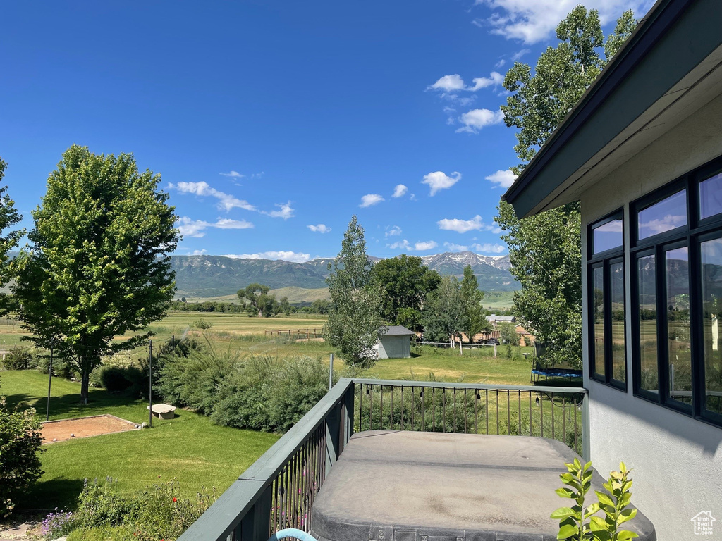 View of patio / terrace featuring a mountain view and a rural view