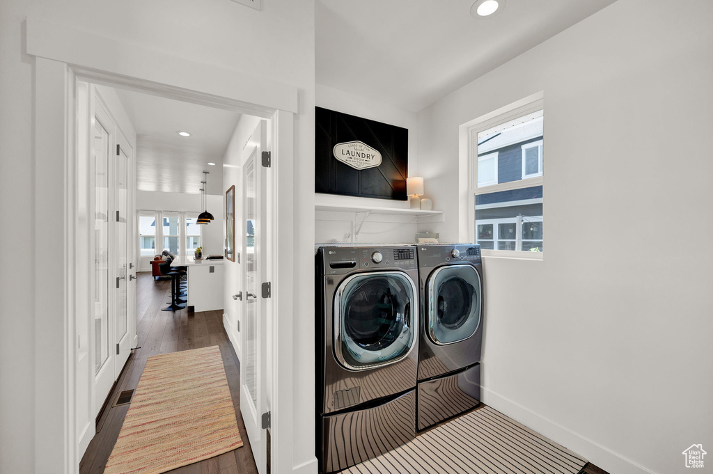 Washroom featuring independent washer and dryer and hardwood / wood-style flooring