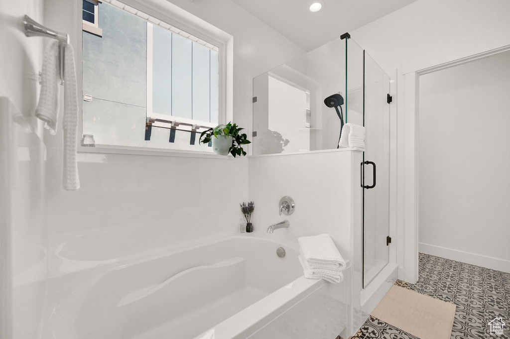 Bathroom featuring tile floors and independent shower and bath