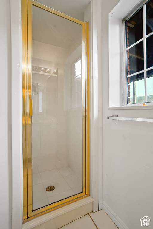 Bathroom featuring walk in shower and tile flooring
