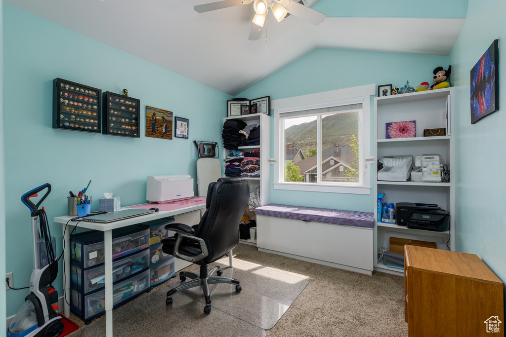Office space featuring carpet floors, ceiling fan, and vaulted ceiling