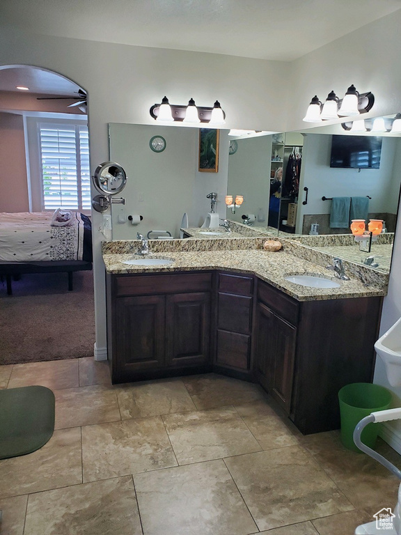 Bathroom with oversized vanity, ceiling fan, tile floors, and double sink