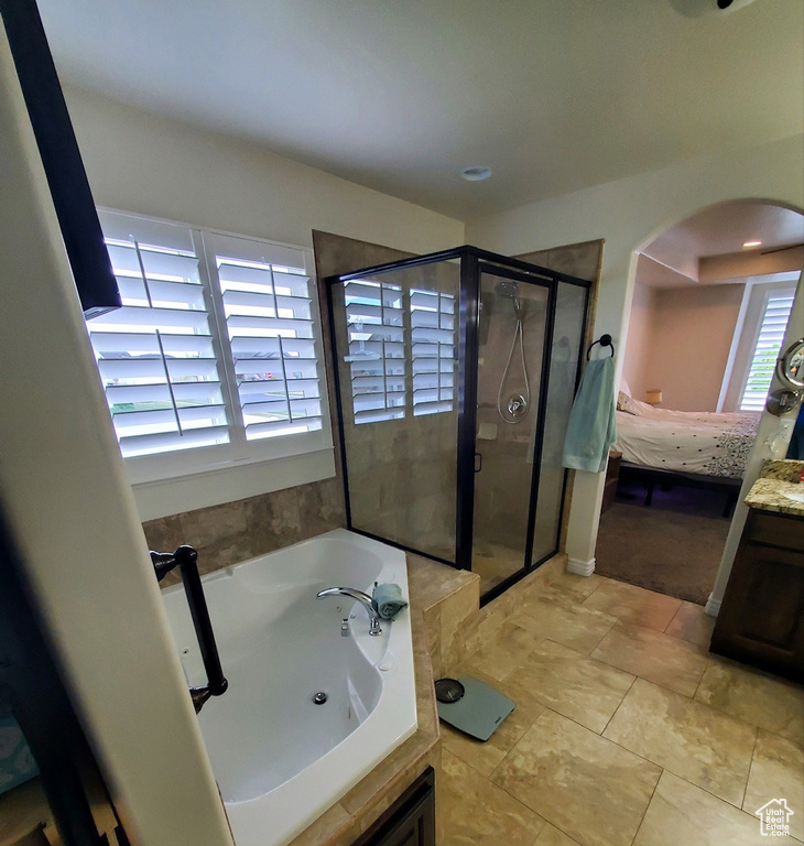 Bathroom with tile flooring and separate shower and tub