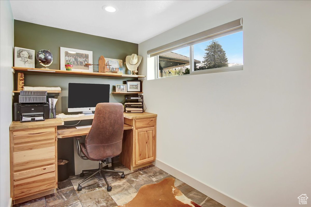Office featuring built in desk and tile floors
