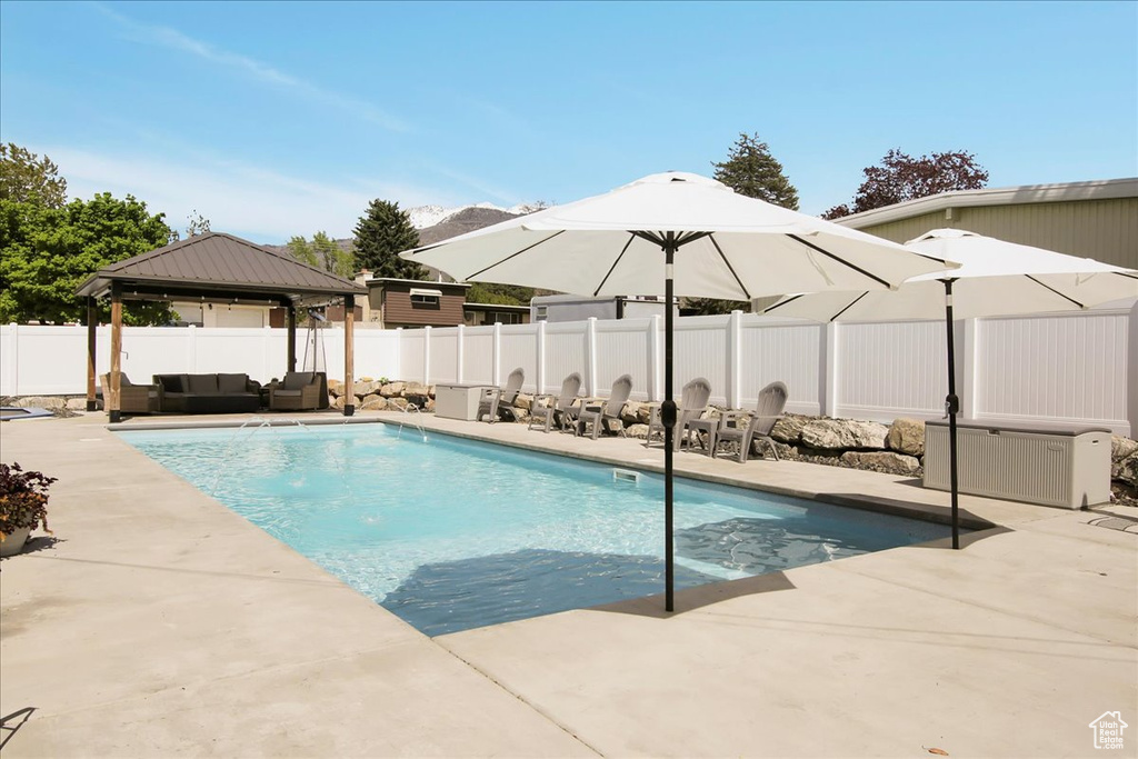 View of swimming pool featuring a patio and a gazebo