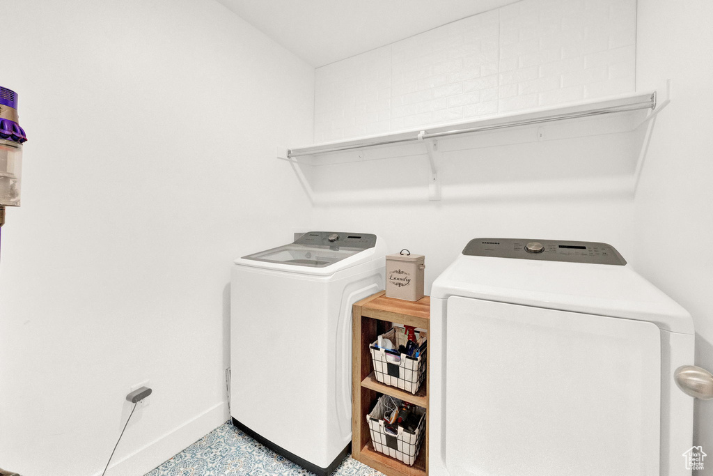 Laundry area featuring independent washer and dryer and tile floors