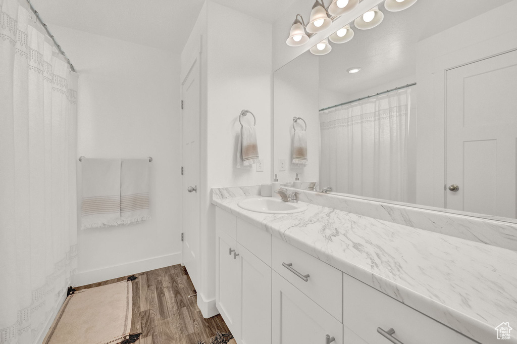 Bathroom featuring hardwood / wood-style flooring and large vanity