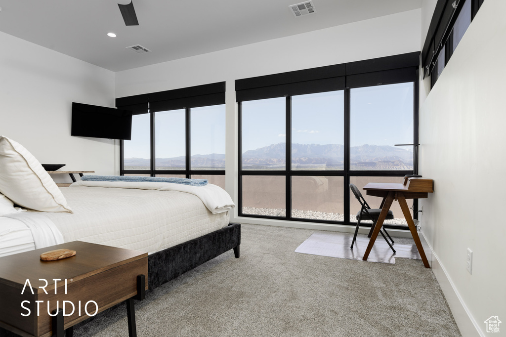 Bedroom with a mountain view, carpet flooring, and ceiling fan