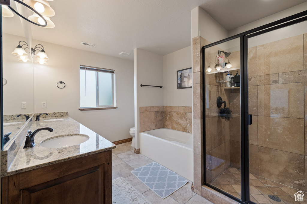 Full bathroom featuring dual bowl vanity, toilet, tile flooring, separate shower and tub, and an inviting chandelier