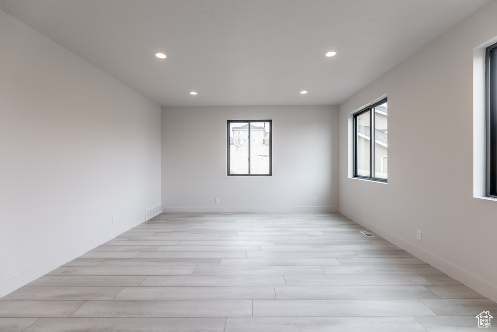 Empty room with plenty of natural light and light wood-type flooring
