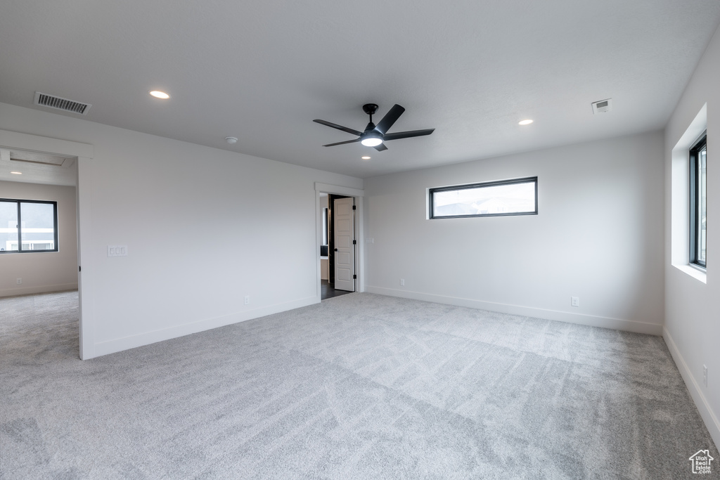 Unfurnished room featuring carpet flooring and ceiling fan