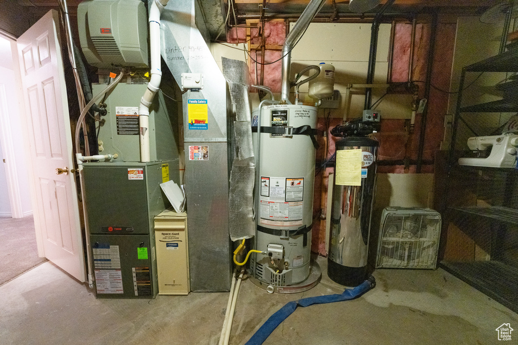 Utility room with heating utilities and strapped water heater