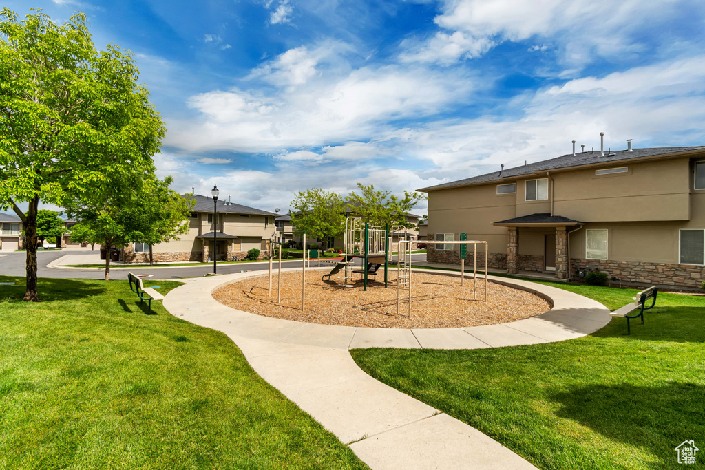 Surrounding community with a lawn and a playground